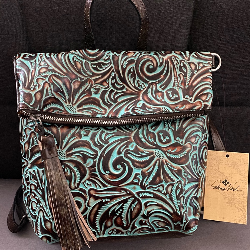 Turquoise tooled interchangeable backpack. Like new does not have tags.